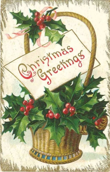 Historical postcard. The postcard is an illustration of a basket with a handle full of holly leaves and berries. There is a card in the basket which reads "Christmas Greetings" in gold and red letters. The postcard is edged in a gold border. 